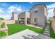 Expansive backyard featuring green grass, a covered patio, and privacy fencing at 4428 Mural Glen Ct, North Las Vegas, NV 89084