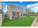 Spacious backyard with lush green grass, patio area, and well-maintained landscaping at 4428 Mural Glen Ct, North Las Vegas, NV 89084