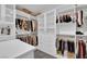 Customized walk-in closet with shelving, drawers, and hanging rods for organized storage at 4428 Mural Glen Ct, North Las Vegas, NV 89084
