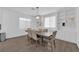 Elegant dining room with a wooden table, six chairs, built-in shelving, and bright windows at 4428 Mural Glen Ct, North Las Vegas, NV 89084