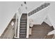 Aerial view of the entryway showing staircase, tiled floor, and modern decor at 4428 Mural Glen Ct, North Las Vegas, NV 89084