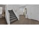 Inviting entryway with stylish tile flooring, staircase, and decorative mirror at 4428 Mural Glen Ct, North Las Vegas, NV 89084