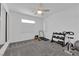 Home exercise room with carpet flooring, ceiling fan, and workout equipment at 4428 Mural Glen Ct, North Las Vegas, NV 89084