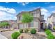 Inviting two-story home featuring a brick driveway, two-car garage, and attractive landscaping at 4428 Mural Glen Ct, North Las Vegas, NV 89084