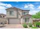 Charming two-story home with a brick driveway, two-car garage, and well-maintained landscaping at 4428 Mural Glen Ct, North Las Vegas, NV 89084