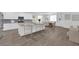 Modern kitchen with stainless steel appliances, an island with seating, and a dining area at 4428 Mural Glen Ct, North Las Vegas, NV 89084