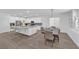 Open concept kitchen with an island, stainless steel appliances, a breakfast bar, and an adjacent dining area at 4428 Mural Glen Ct, North Las Vegas, NV 89084