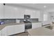 Kitchen features white cabinets, stainless steel appliances, stone countertops, and attractive tile backsplash at 4428 Mural Glen Ct, North Las Vegas, NV 89084
