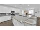 Bright kitchen featuring white cabinets, stainless steel appliances, and a large island with seating at 4428 Mural Glen Ct, North Las Vegas, NV 89084