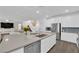 Stylish kitchen with stainless steel appliances, a large island, and open layout to the living area at 4428 Mural Glen Ct, North Las Vegas, NV 89084