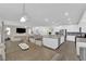 Open concept floor plan, adjacent to the kitchen, and featuring a dining area and living room at 4428 Mural Glen Ct, North Las Vegas, NV 89084