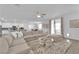 Open-concept living area with a sectional sofa, modern decor, and views of the kitchen and dining spaces at 4428 Mural Glen Ct, North Las Vegas, NV 89084
