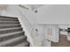 Bright staircase with carpeted steps and white banister, leading to upper level at 4428 Mural Glen Ct, North Las Vegas, NV 89084