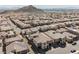 Aerial shot of a residential neighborhood showcasing houses against the backdrop of mountains and a distant city at 4576 Amazing View St, Las Vegas, NV 89129