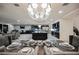 Elegant dining room with formal table setting, stylish chandelier, and views into the living spaces at 4576 Amazing View St, Las Vegas, NV 89129