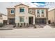 Stunning two-story home with a stone and stucco facade, well-manicured landscaping, and modern garage doors at 4576 Amazing View St, Las Vegas, NV 89129