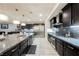 Gourmet kitchen featuring an island, stainless steel appliances, dark cabinetry and backsplash at 4576 Amazing View St, Las Vegas, NV 89129