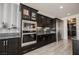 Elegant kitchen featuring stainless steel appliances, sleek cabinetry, and direct access to butler's pantry at 4576 Amazing View St, Las Vegas, NV 89129