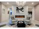 Modern living room with a fireplace, chandelier, and plush seating at 4576 Amazing View St, Las Vegas, NV 89129