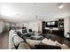 Open concept living room with hardwood floors, a ceiling fan, recessed lighting, and a large grey sectional at 4576 Amazing View St, Las Vegas, NV 89129