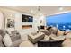 Luxurious living room with comfortable seating, modern fireplace, and a wall of windows leading to the pool at 4576 Amazing View St, Las Vegas, NV 89129