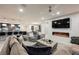 Open-concept living space with modern fireplace, sleek furniture, and seamless flow to the kitchen and dining area at 4576 Amazing View St, Las Vegas, NV 89129