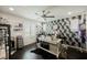 Bright office with a dark wood floor, desk with an area rug, and a decorative accent wall at 4576 Amazing View St, Las Vegas, NV 89129