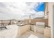 This outdoor kitchen is fully equipped with a grill and mini fridge at 4576 Amazing View St, Las Vegas, NV 89129