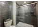 A glass shower with gray tiling, a bench seat, and stylish design at 4576 Amazing View St, Las Vegas, NV 89129