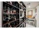 Spacious wine cellar with custom shelving, ample storage for wine bottles, and a dedicated tasting area at 4576 Amazing View St, Las Vegas, NV 89129