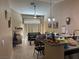 Open-concept living area connecting to kitchen, featuring a ceiling fan, fireplace, and natural light, great for entertaining at 5161 Briar Meadow Way, Las Vegas, NV 89118