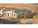 An aerial view of a modern home with a three-car garage and desert landscaping at 52 Reverie Heights Ave, Henderson, NV 89011