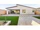 A perfectly manicured lawn and patio area with a retaining wall provides a gorgeous outdoor view at 52 Reverie Heights Ave, Henderson, NV 89011