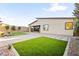 Well-maintained backyard features lush lawn and a gray stone patio, great for outdoor enjoyment at 52 Reverie Heights Ave, Henderson, NV 89011