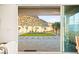 View of a beautifully landscaped backyard from the indoor dining area through the sliding glass doors at 52 Reverie Heights Ave, Henderson, NV 89011
