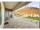 Covered patio with seating area offers an incredible view of the landscaped backyard and hillside at 52 Reverie Heights Ave, Henderson, NV 89011