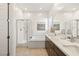 Modern bathroom features a glass-enclosed shower, soaking tub, double vanity and sleek finishes at 52 Reverie Heights Ave, Henderson, NV 89011