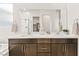 Bathroom featuring a double sink vanity, large mirror, and modern fixtures at 52 Reverie Heights Ave, Henderson, NV 89011