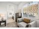 Bright bedroom with a chair, dresser, and large window for ample natural light at 52 Reverie Heights Ave, Henderson, NV 89011