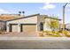 Modern home featuring a three-car garage, desert landscaping, and a stone accented facade at 52 Reverie Heights Ave, Henderson, NV 89011
