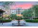 Exterior view of a hotel-style building surrounded by landscaped grounds with a fountain at 52 Reverie Heights Ave, Henderson, NV 89011