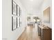 Bright hallway features wood floors, elegant decor, and leads into an open-concept living space at 52 Reverie Heights Ave, Henderson, NV 89011