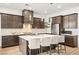 Beautiful, modern kitchen featuring a marble countertop island, dark cabinetry, and stainless steel appliances at 52 Reverie Heights Ave, Henderson, NV 89011