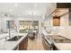 Bright kitchen with stainless steel appliances, island sink, and view to the outdoor dining area at 52 Reverie Heights Ave, Henderson, NV 89011