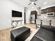 Stylish living area with an open kitchen, modern furniture, and a sleek entertainment center at 52 Reverie Heights Ave, Henderson, NV 89011