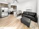 Bright and airy living room with stainless steel appliances, a breakfast bar, and a comfortable sofa at 52 Reverie Heights Ave, Henderson, NV 89011
