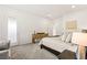 Bright main bedroom with plush carpet, ensuite bathroom, and comfortable seating at 52 Reverie Heights Ave, Henderson, NV 89011