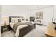 A bright, spacious main bedroom with carpet, natural light, and a cozy sitting area at 52 Reverie Heights Ave, Henderson, NV 89011