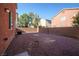A rockscaped backyard features an air conditioning unit and block wall at 5573 La Perla Ct, Las Vegas, NV 89122