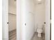 Neutral bathroom features a toilet, a towel rack, and a view into a walk-in closet at 5573 La Perla Ct, Las Vegas, NV 89122